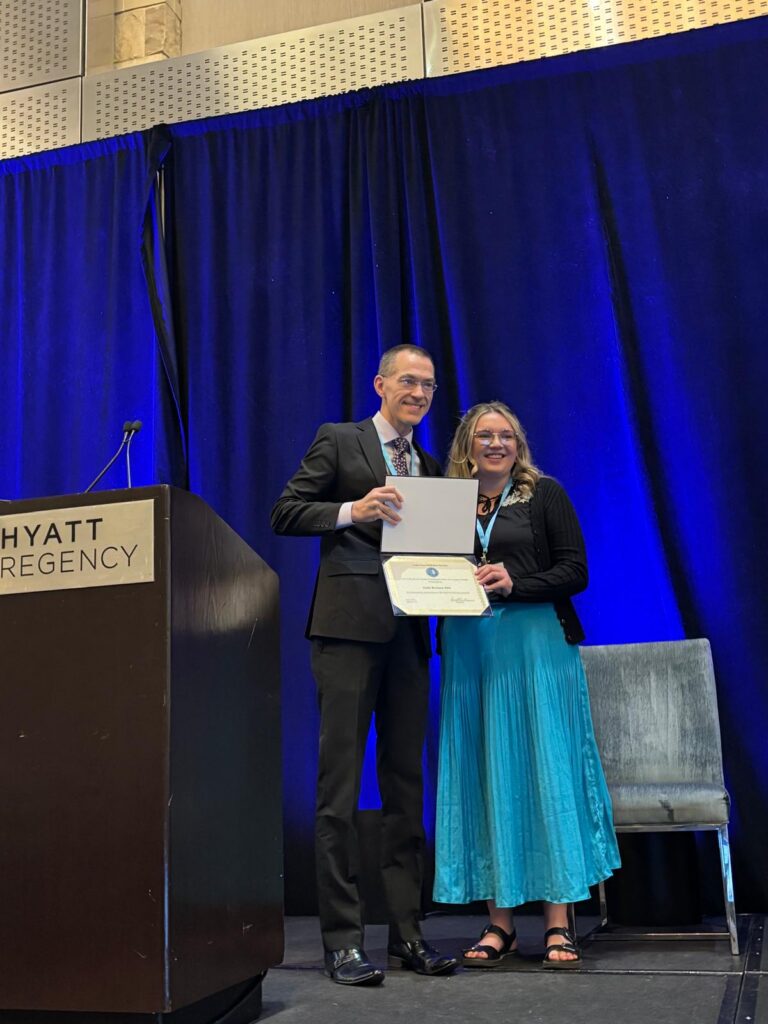 Emily Bowman accepting award at American Delirium Society meeting